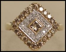 A hallmarked 9ct gold diamond cluster ring set with champagne and white diamonds in a geometric