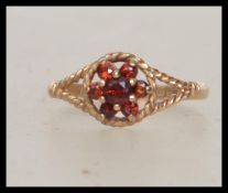 A 9ct gold hallmarked ladies cluster ring with topaz coloured stone in a cluster with rope twist