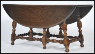A 20th century Ercol coffee table of rectangular form having an elm top raised over bobbin turned
