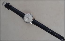 A vintage Longines gentleman's wristwatch having a silvered dial with baton and numeral markers