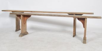 A near pair of 19th century French country pine refectory pig benches. Each with shaped single plant