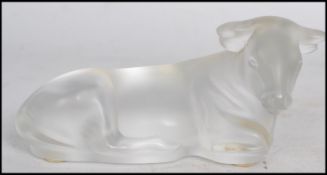 Lalique frosted glass paperweight formed as a recumbent cow, having acid etched inscription to the