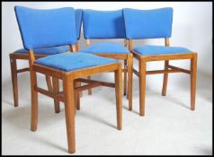 A set of 4 1930's oak dining chairs having square tapered legs with blue vibrant fabric drop in