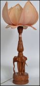 A  mid century Chinese lotus flower lamp having carved hardwood base in the form of elephants having