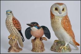 A group of three Beswick ceramic bird figures to include Kingfisher, Kestrel and Barn Owl. Measures: