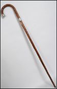 A silver collar blackthorn walking stick hacing a crook handle with tapering stem. Hallmarks for