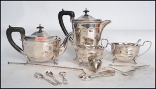 A four piece Sheffield silver plate tea service having ebonised handles along with a collection of