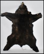 A large antique mounted Van Ingen Bearskin / Beak Skin complete with the claws being set to a wooden