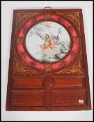 A 20th century Chinese ceramic circular plaque decorated in enamels with garden figural scene and