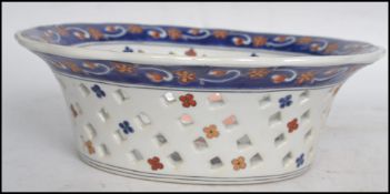 A Chinese decorative fret pierced bowl having an applied central  panel depicting a tall ship at