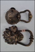 Two vintage style cast iron architectural doorknockers one in the form of a lion and one in the form