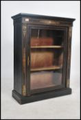 A Victorian ebonised and walnut pier cabinet,with satinwood stringing, single glazed door and ormolu