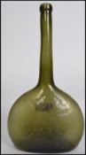 An 18th /19th century green glass bottle with unusual tall neck having onion shaped thin base.