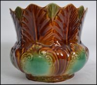 An early 20th century Art Nouveau drop glazed planter having a scalloped top with turquoise and