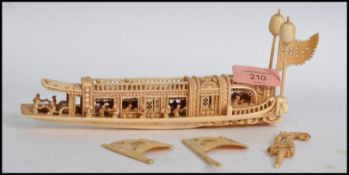 A 19th century Chinese carved ivory junk decorated with numerous figures (some damages and