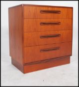 A 1970's G-Plan teak wood Kelso Pattern chest of drawers being raised on an inset plinth with