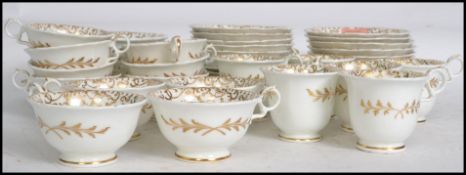 A vintage 20th century bone China tea service decorated with hand applied gilt overlay, consisting