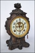An ornate 19th century cast metal  Ansonia sculptural mantel clock, the movement with revealed