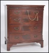 A Mahogany Georgian style bow front bachelors chest of drawers having four long drawers chest with