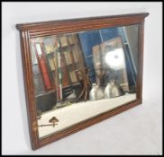 A large Victorian oak overmantel mirror. The reeded frame with large bevelled glass plate mirror