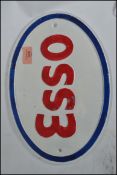 A vintage style painted cast iron Esso advertising point of sale plaque sign of oval form having a