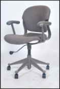 A vintage 20th century retro Herman Miller swivel office chair having an upholstered seat and back