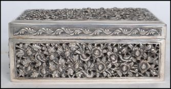 An early 20th century Oriental Chinese silver table top cigarette box of rectangular form having a