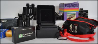 A collection of camera's and binoculars to include Canon AE-1 SLR camera together with leather cased