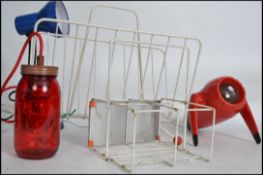 A collection of 5x retro items to include; blue desk lamp, Red spaceship- like projector, Jam Jar
