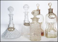 A collection of decanters to include a pair of white metal collar Holmegaard Kluk Kluk decanters a