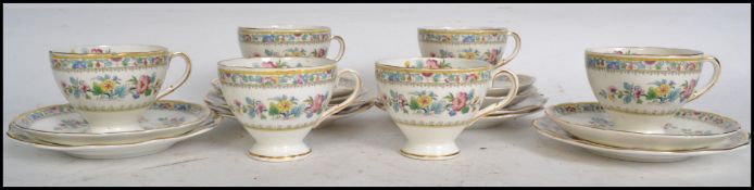 A set of six Foley ceramic china trios in the Ming Rose pattern consisting of cups, saucers and