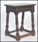 A believed 18th / 19th century country oak peg jointed stool raised on gun barrel turned legs united
