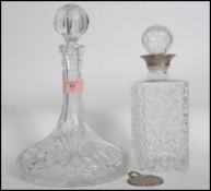 A vintage 20th century cut glass ships decanter together with another decanter with white metal