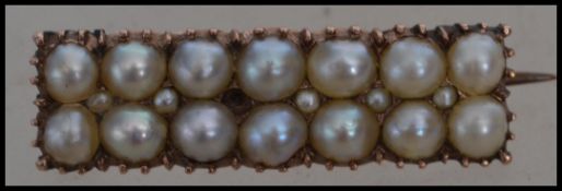 A Victorian gold and pearl brooch pin set with a graduating pearl design having a C clasp.