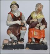 A pair of 19th Century Staffordshire pottery figures of the Cobbler and his wife on square bases.