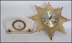 A vintage retro 20th century star burst / sun burst wall clock having faceted hands along with an