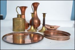 A collection of copper and brass metal wares to include an arts and crafts dish, plates,