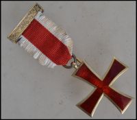 A gilded silver Masonic Brooch with inset enamelled centre  being set to a ribbon and bar with pin