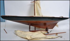A vintage 20th century scratch built model boat having painted black band with masts and sails set