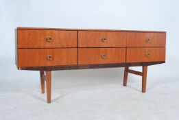 A 1970's retro Long John teak wood Danish influence sideboard raised on tapering legs having a