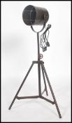 A vintage retro industrial style metal tubular tripod floor  spot lamp, having an adjustable tubular