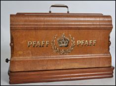 A good Edwardian Pfaff hand crank sewing machine complete in the original wooden case together
