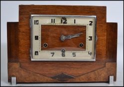 A 1920s Art Deco mantel clock with square face having an Arabic numeral dial enclosing three train