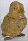 A 19th century cold painted pewter vesta in the form of a chick having hinged head with strike to