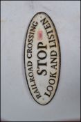 A vintage style cast iron railway cross roads sign of rectangular form notated stop look and