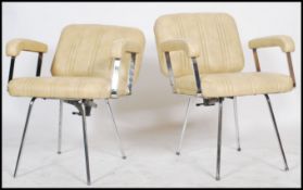 A pair of vintage 20th century retro reclining chairs of chrome construction having vinyl seats