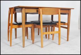 A 1970's retro teak wood Danish inspired extending dining table and 4 chairs. The table with