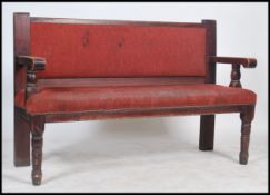 A mid century solid wood municipal railway / train station waiting room interior bench seat with