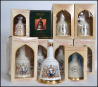 A collection of eleven commemorative Bells Whisky decanters by Wade, with contents in original