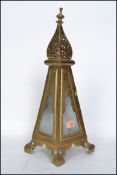 An Arts & Crafts brass table lantern with frosted glass windows, the case of tapering form with door